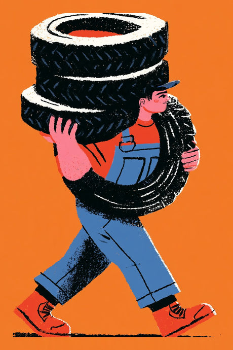 Mechanic Carries Tires